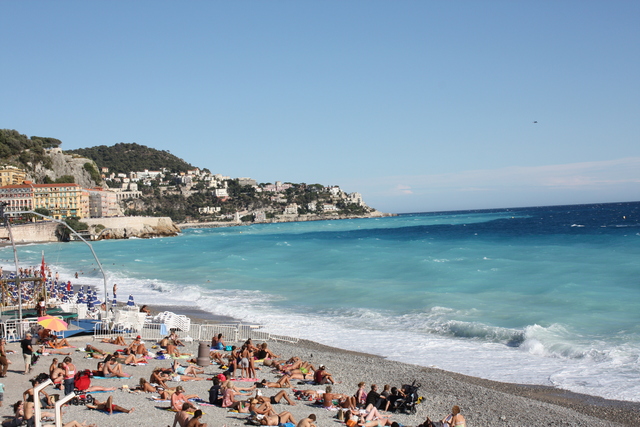 ニース・ビーチで日光浴をする人々の写真の写真